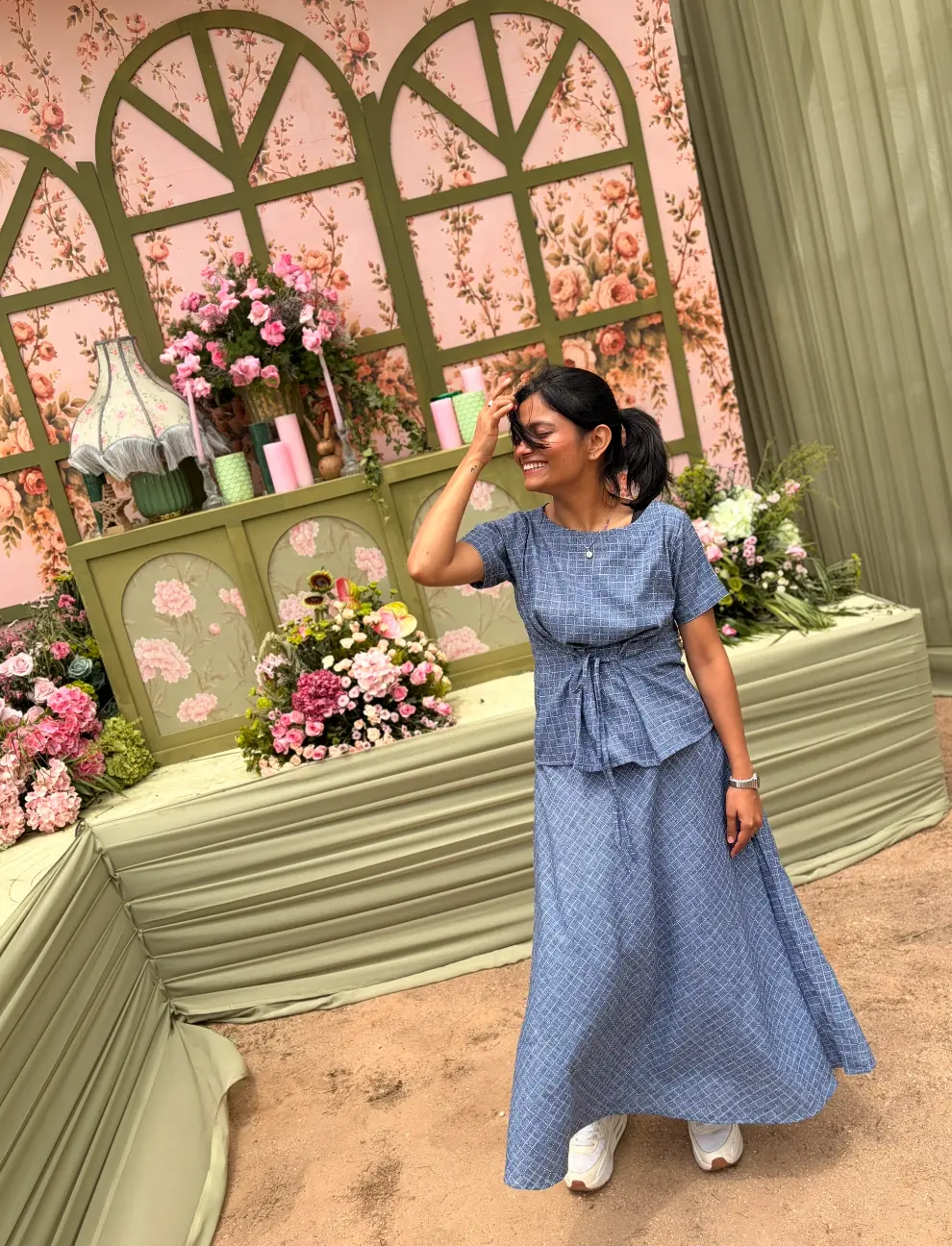 Shivani Mahajan reviewing a floral installation on site